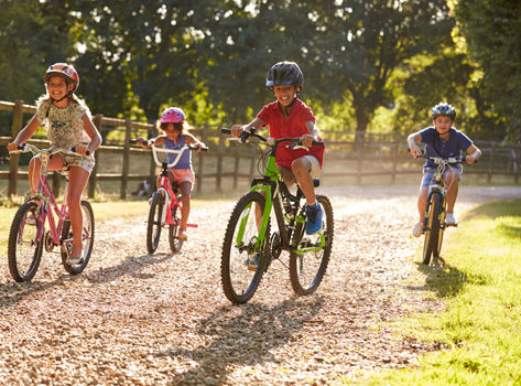 A group of children enjoying a safe summer bike ride.