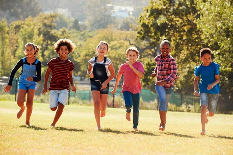 Happy children running in a field