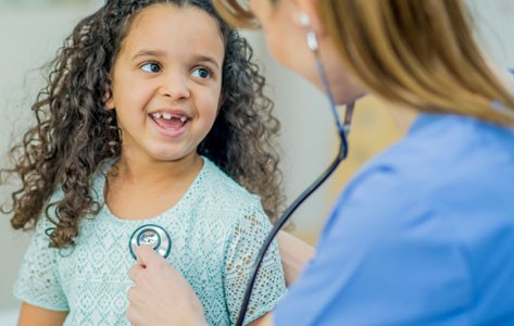 Doctor examines pediatric cancer patient