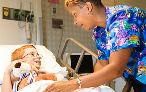 Nurse provides palliative care to sick boy