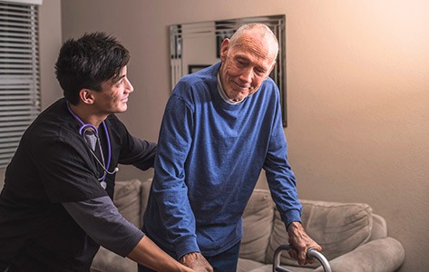 Physical therapist helps patient with movement disorder
