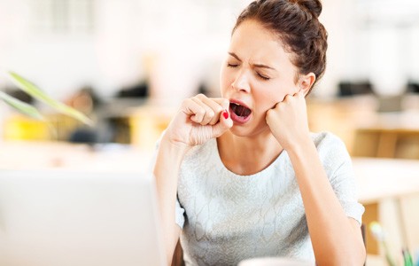 Woman with sleep disorder yawning