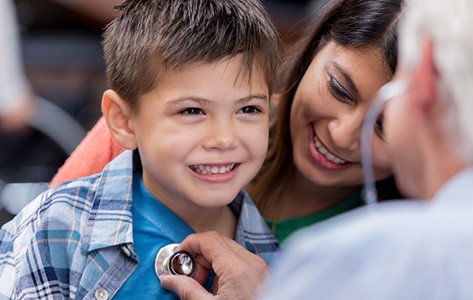 Advanced Urgent Care physician examines young boy