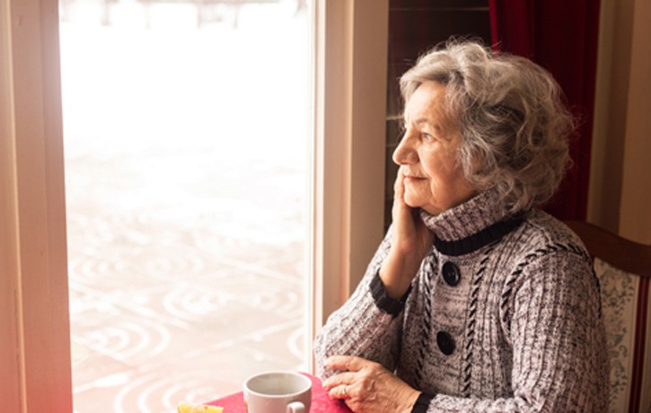 older women looking out window