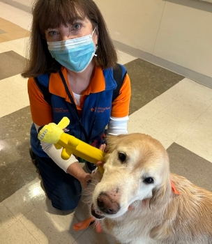 Hospital volunteer with therapy dog.