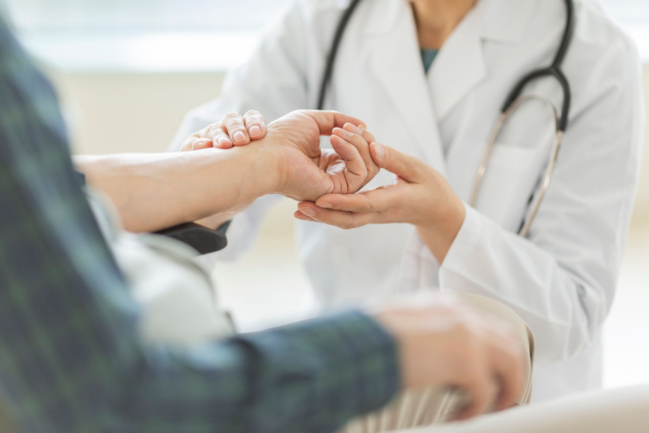Orthopedist holding a patient's wrist.