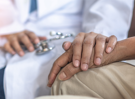 Close-up of doctor holding patient's hand